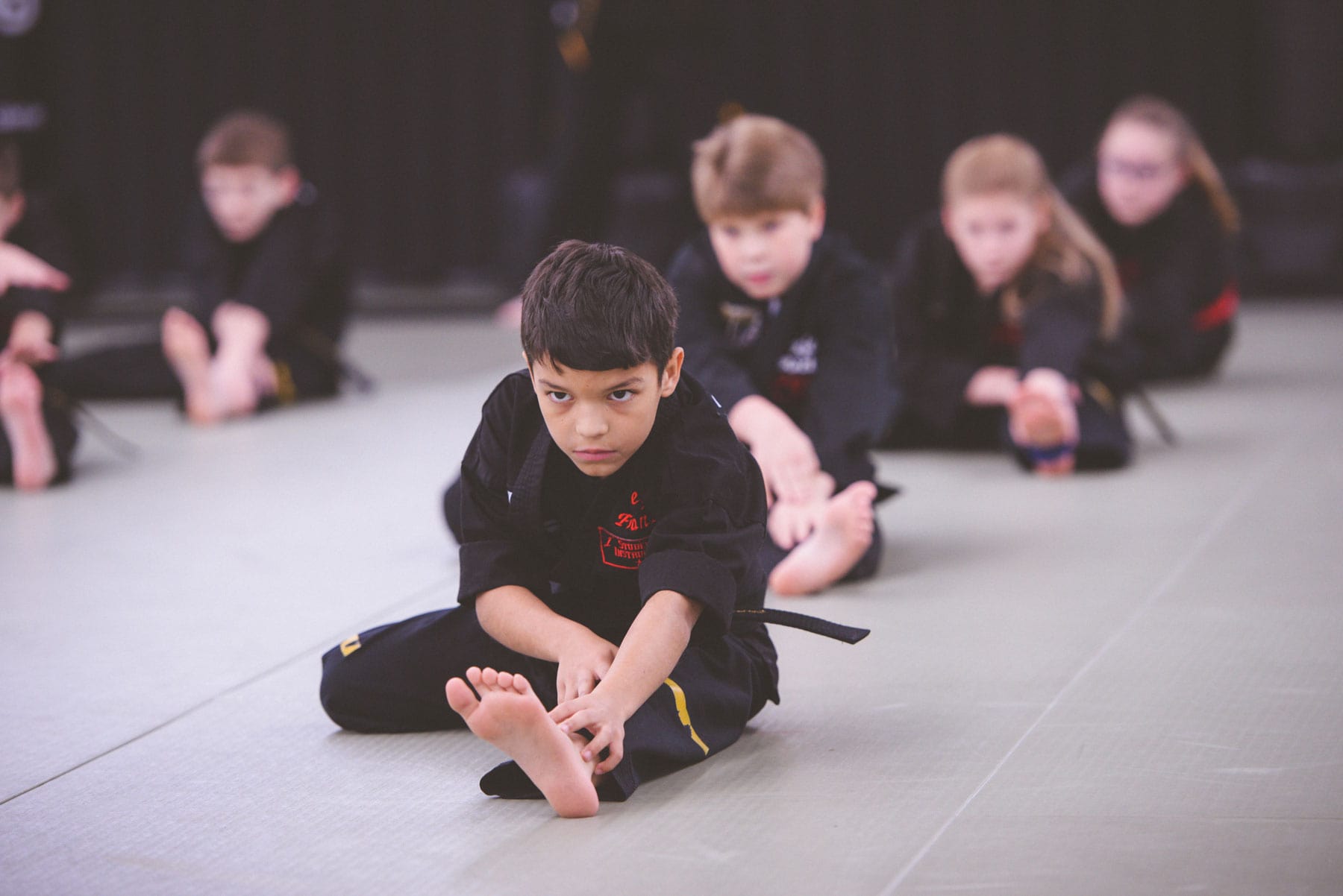 Warrior kids stretching at Ultimate Leadership Martial Arts Cincinnati